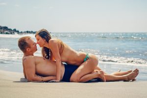 friends in a sexy position on a beach bank